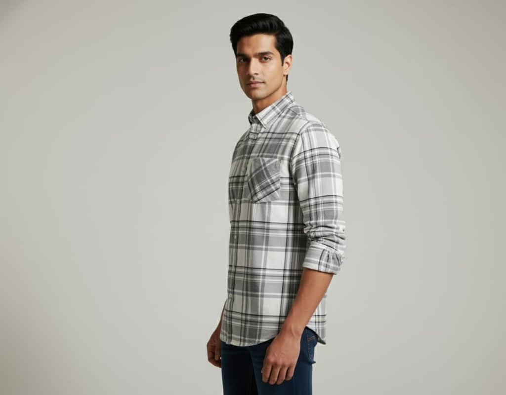 Man wearing a plaid shirt on a gray background