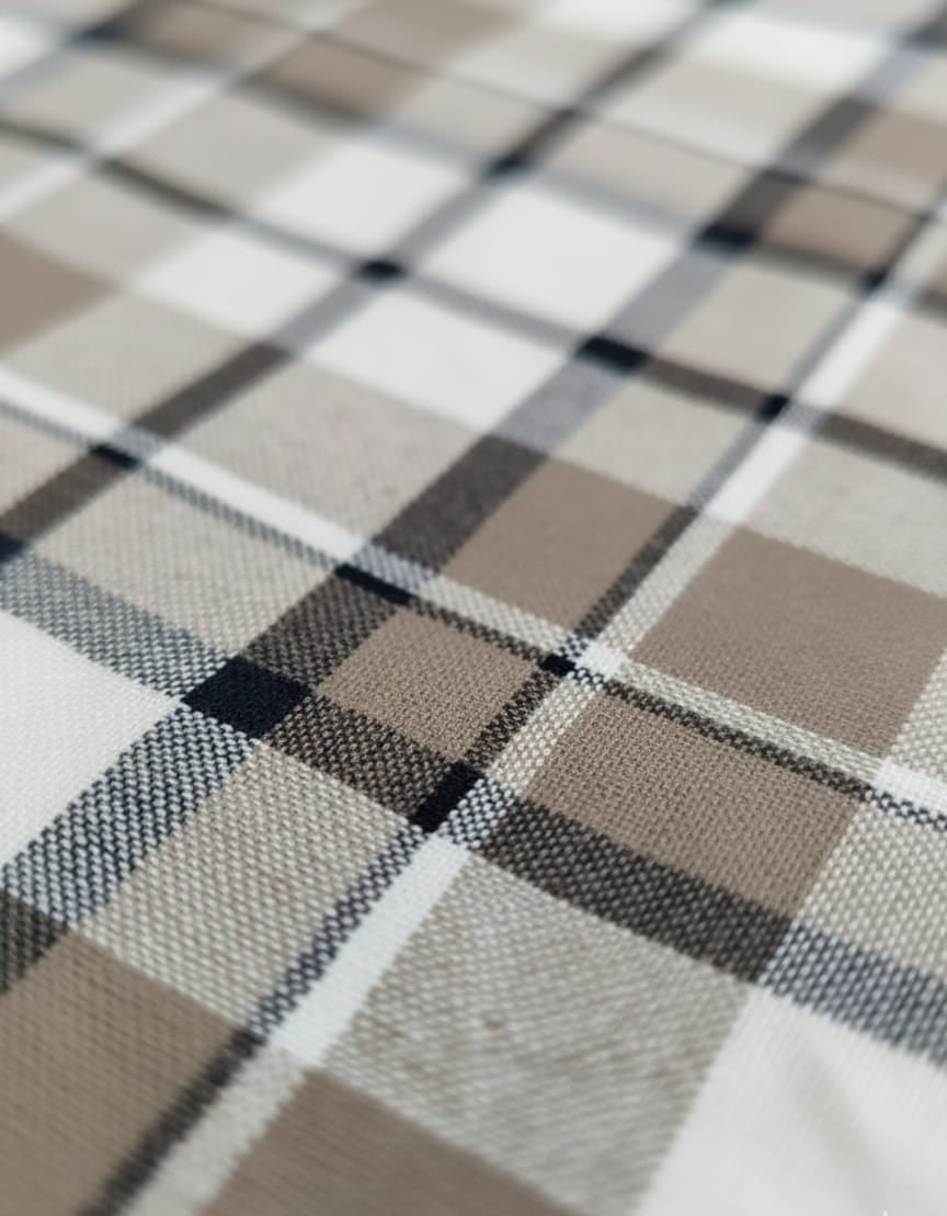 Close-up of a checkered fabric with brown, black, and white colors.