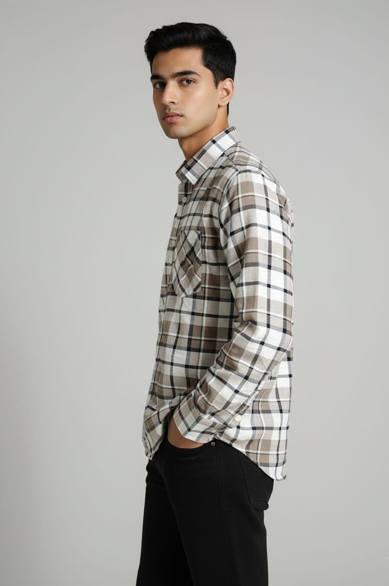 Man wearing a plaid shirt against a gray background
