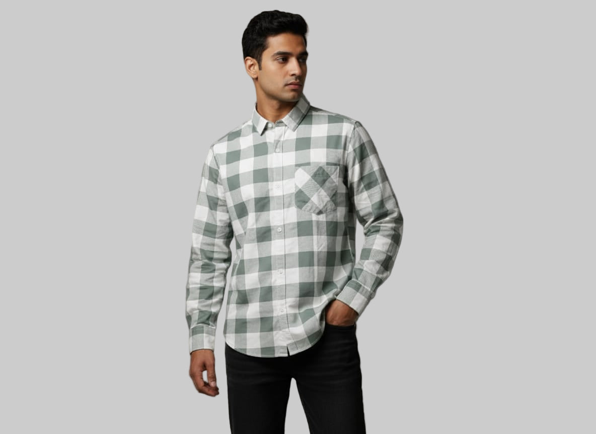 Man wearing a green and white checkered shirt against a gray background